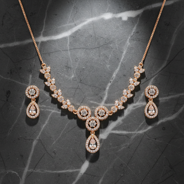 Rose gold pavé crystal floral necklace and earring set on dark luxury background