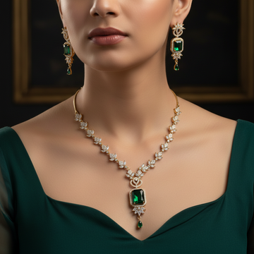 Gold emerald green bridal jewelry set with maang tikka worn on neck and ears