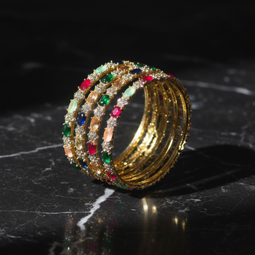 Multicolor oval gemstone gold bangle set on dark luxury background