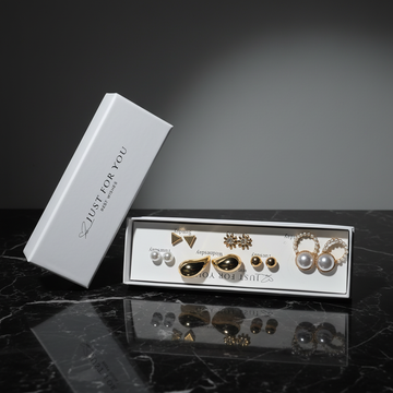 Gold weekly earring set in Just For You white gift box on dark background