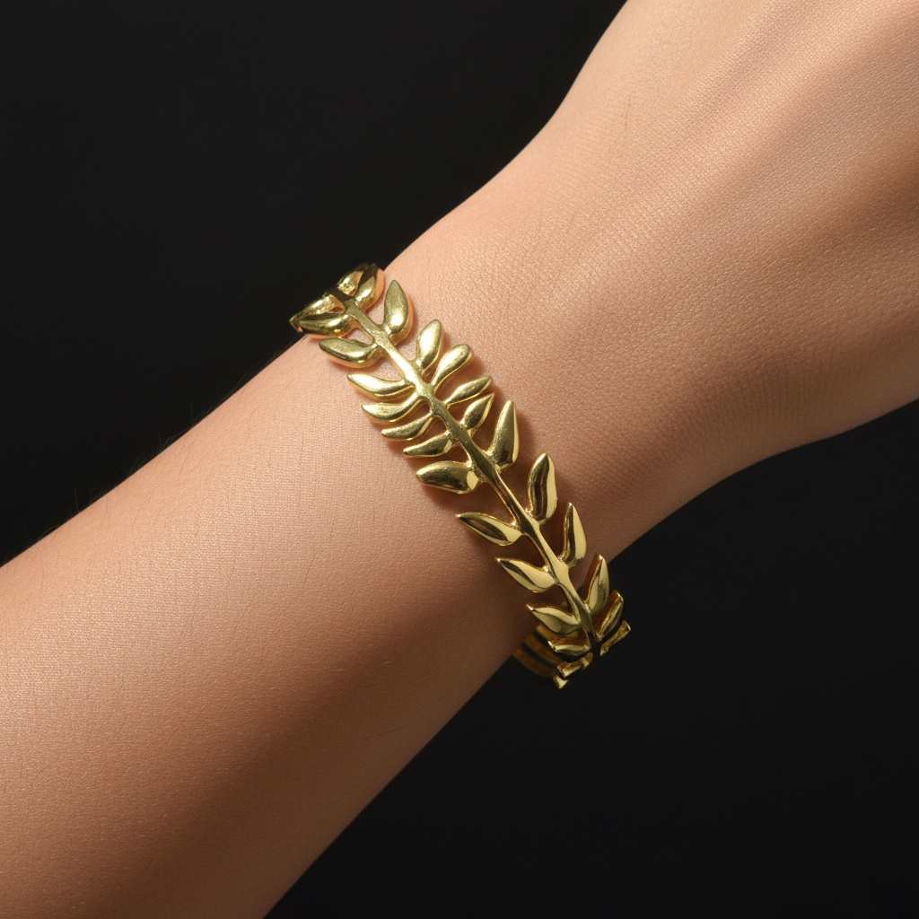 Gold leaf branch open cuff bangle worn on wrist