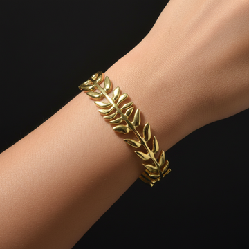 Gold leaf branch open cuff bangle worn on wrist