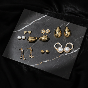 Gold 7 pairs weekly earring set on dark luxury background