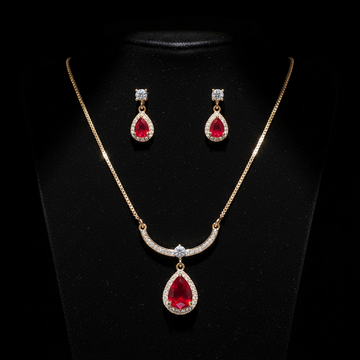 Gold ruby teardrop necklace and earring set on dark luxury background