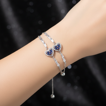 Silver double blue sapphire heart bracelet worn on wrist